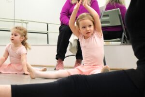 Little girls stretching in ballet class